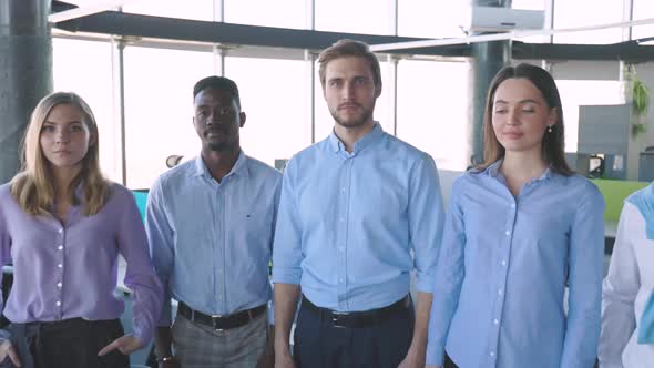 Group of Businesspeople Standing Together in Office alt