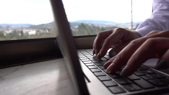Hands Typing on Laptop keyboard alt