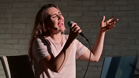 Woman Recording Vocal Lesson Using Laptop While Staying at Home alt