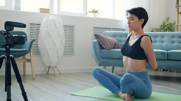 Female Vlogger Talking and Training Arms Recording Video for Online Vlog at Home alt