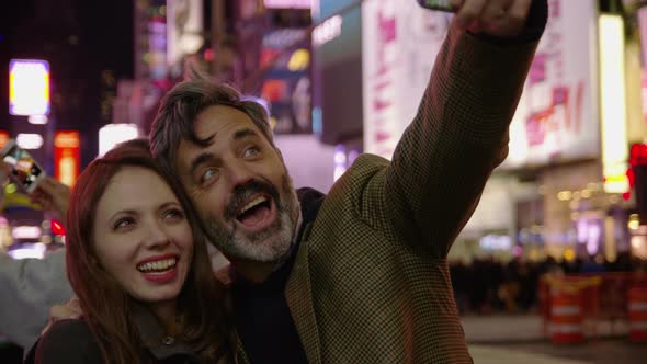 Couple taking selfie in Times Square, New York City