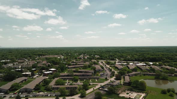 residential apartments and houses with blue skyes in Willowbrook Illinois aerial view 4k alt