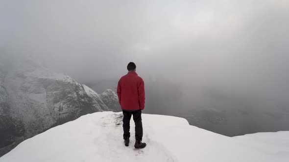 Hiker Looking Over Misty Mountains Of Lofoten alt