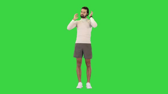 Attractive Fit Caucasian Sportsman Doing Warm Up Exercises for Neck on a Green Screen Chroma Key
