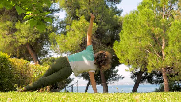 European Woman Doing Yoga and Relaxation Exercises Outdoors