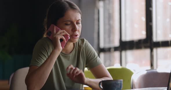 Portrait of Young Attractive Concerned Woman with Brunette Hair Talking on Mobile Phone While alt