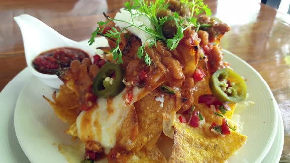 Mexican Food Appetizer Nachos With Salsa And Cheese Sour Cream And Corn Tortilla Chips