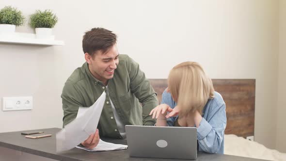 Happy Married Couple Use Laptop at Home While Home Audit alt