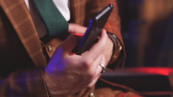 Closeup of Men's Hands with a Smartphone