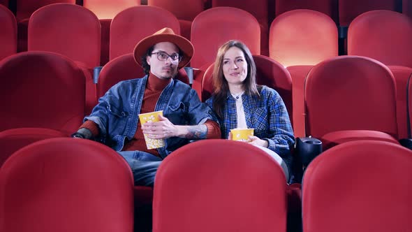 Friends Laugh While Watching Comedy at the Cinema alt