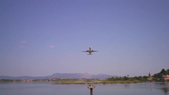 An airplane takes off up into the sky from a landing strip alt