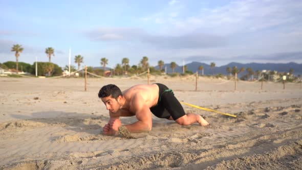 shirtless guy doing crawling exercise on elbows in the morning alt