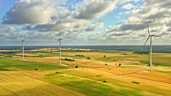 Wind turbines on field in summer, aerial view alt