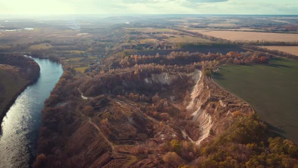 Drone footage of abandoned chalk quarry near the river