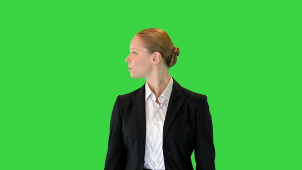 Young Woman Walking Through Museum or Exhibition Looking To the Sides on a Green Screen Chroma Key alt