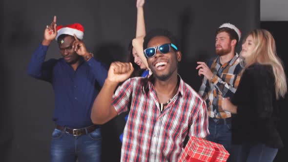 Young Multiethnic Friends Dancing at Christmas Party