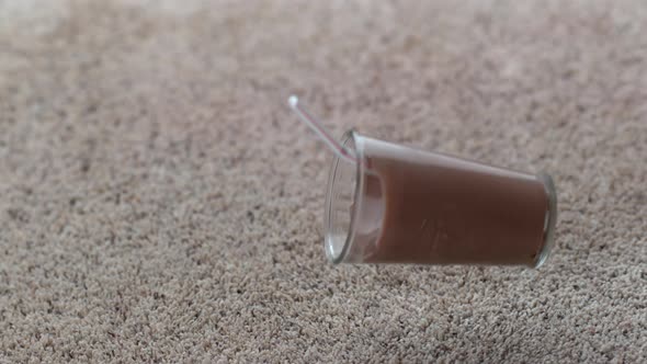 Glass of chocolate milk spilling on carpet in slow motion; shot on Phantom Flex 4K at 1000 fps alt