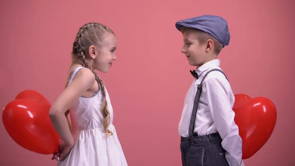 Couple of Cute Kids Exchanging Red Heart-Shaped Balloons, Valentines Day Gift alt