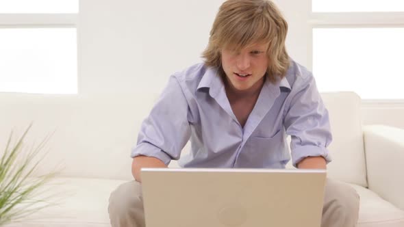 Young man with laptop computer alt