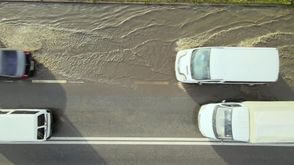 Aerial View of City Traffic with Cars Driving on Flooded Street After Heavy Rain alt