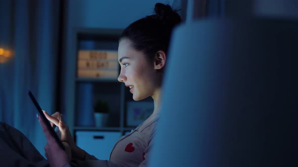 Teenage Girl with Tablet Pc in Bed at Night alt