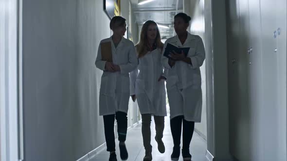 Professional Female Engineers Going through Corridor alt