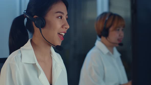 Asia young call center team or customer support service executive using computer and microphone.