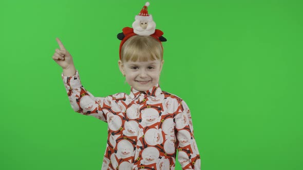 Happy Beautiful Little Girl in a Shirt with a Santa Claus alt