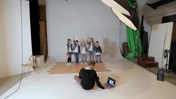 Photographer Taking Pictures of Happy Children Posing in Photo Studio