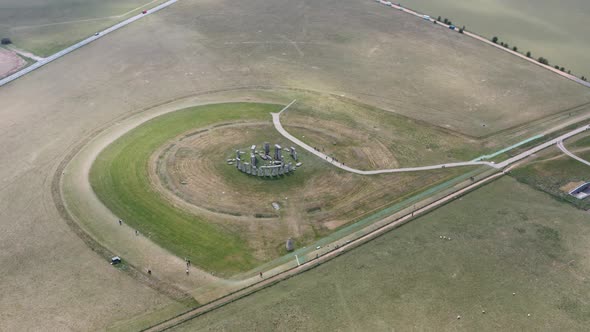 Circling drone shot of empty Stonehenge tourist destination alt