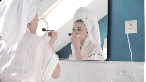 Attractive Woman Applying Cream on Skin Under Eyes at Home