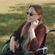 Disabled Young Caucasian Woman Listening the Music in the Park in the Wheelchair - VideoHive Item for Sale