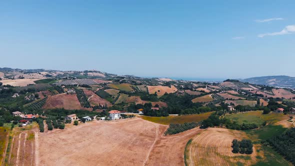 Aerial view of hills and agricultural fields in Marche region, Italy alt