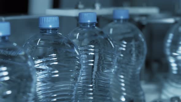 Clean Water in Plastic Bottle Moves Through Conveyor Factory. alt