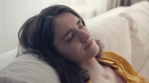Calm and Relaxed Brunette Girl Sitting on the Couch Comfort Zone alt