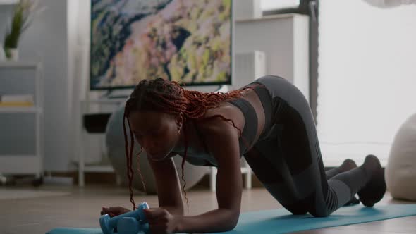 Athlete African in Sportwear Doing Fitness Exercices Putting Cronometer on Phone alt