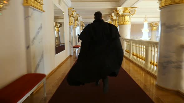 Actor in a Black Suit Runs Down the Corridor of the Theater