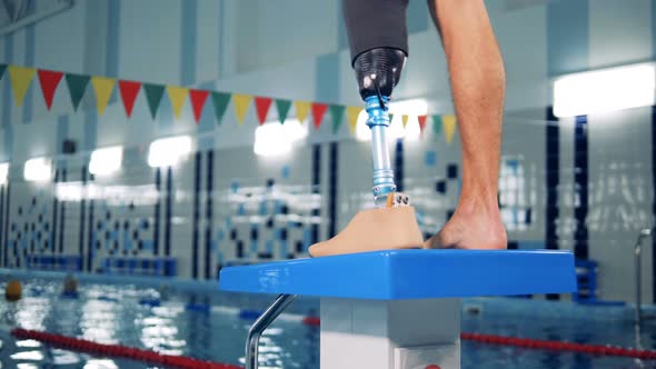 Close Up of a Male Healthy Leg and a Prosthetic One in the Swimming ...