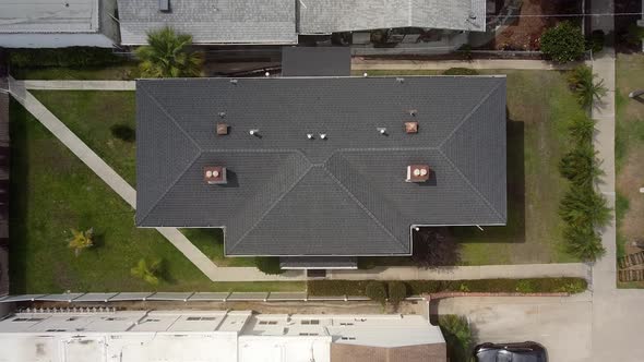 Beautiful villa from top view to see the full property and streets with cars parked around it. Slow alt