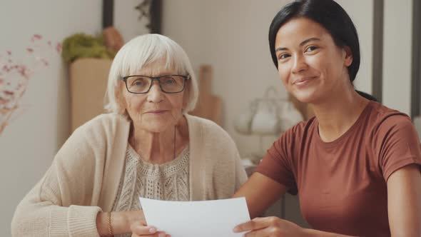 Happy Female Social Worker and Senior Woman Posing for Camera alt