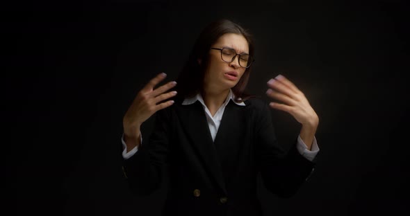 Business Woman Waves Her Hands Near Her Face She is Very Hot alt
