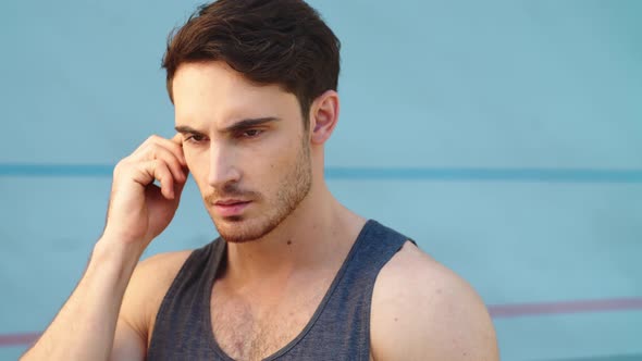 Close Up of Professional Sportsman Listening Music on Track alt