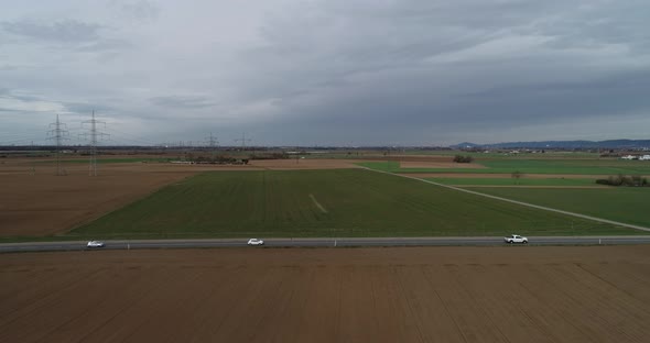 Aerial Drone Content  Road with Light Traffic on Outside City and Arable Lands