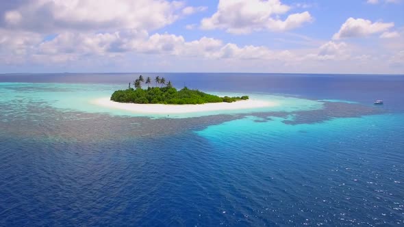 Aerial drone view of a coral reef and scenic tropical island in the Maldives. alt