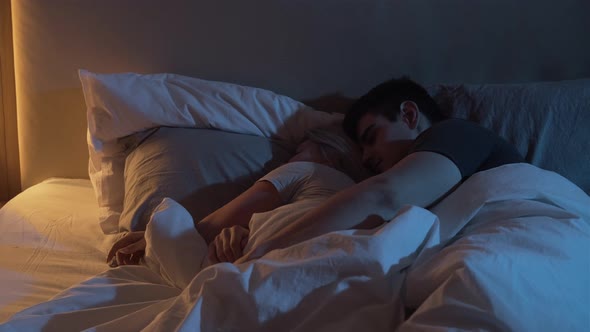 Sleeping Couple Man Embrace Cuddle Wife Bed Night by lgolubovystock