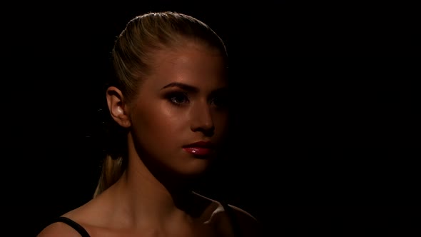 Closeup Face of a Beautiful Young Woman Shows Makeup. Black. Closeup alt