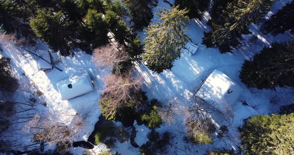 Aerial Winter Landscape Over Small Log Cabin House alt