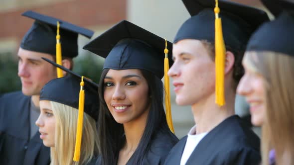Graduate looks at camera alt