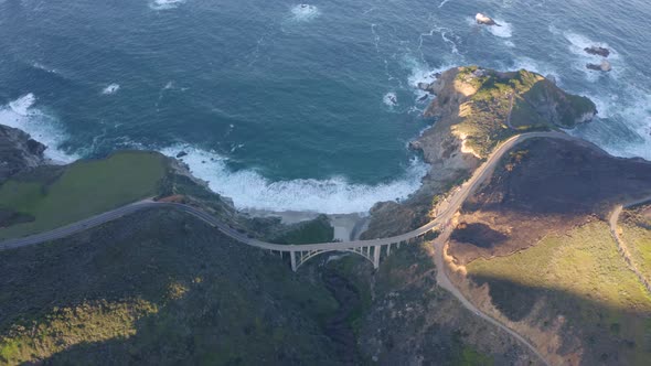 Aerial view of the picturesque arch bridge standing over the canyon.  alt