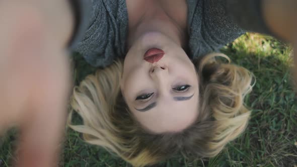 Nice Young Woman Close Eyes Lie On Grass Closeup
